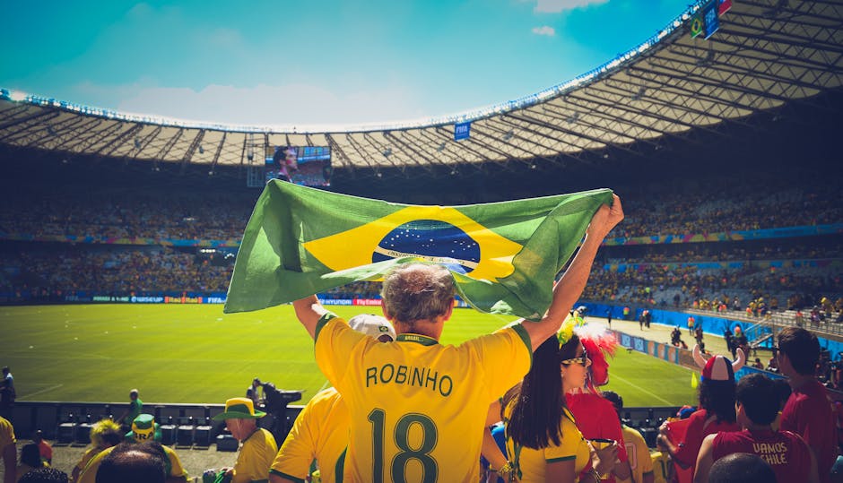 FIFA World Cup 2026 Everything You Need To Know Complete Guide 2026 Excited Brazilian fans holding flag at soccer match in vibrant stadium atmosphere.