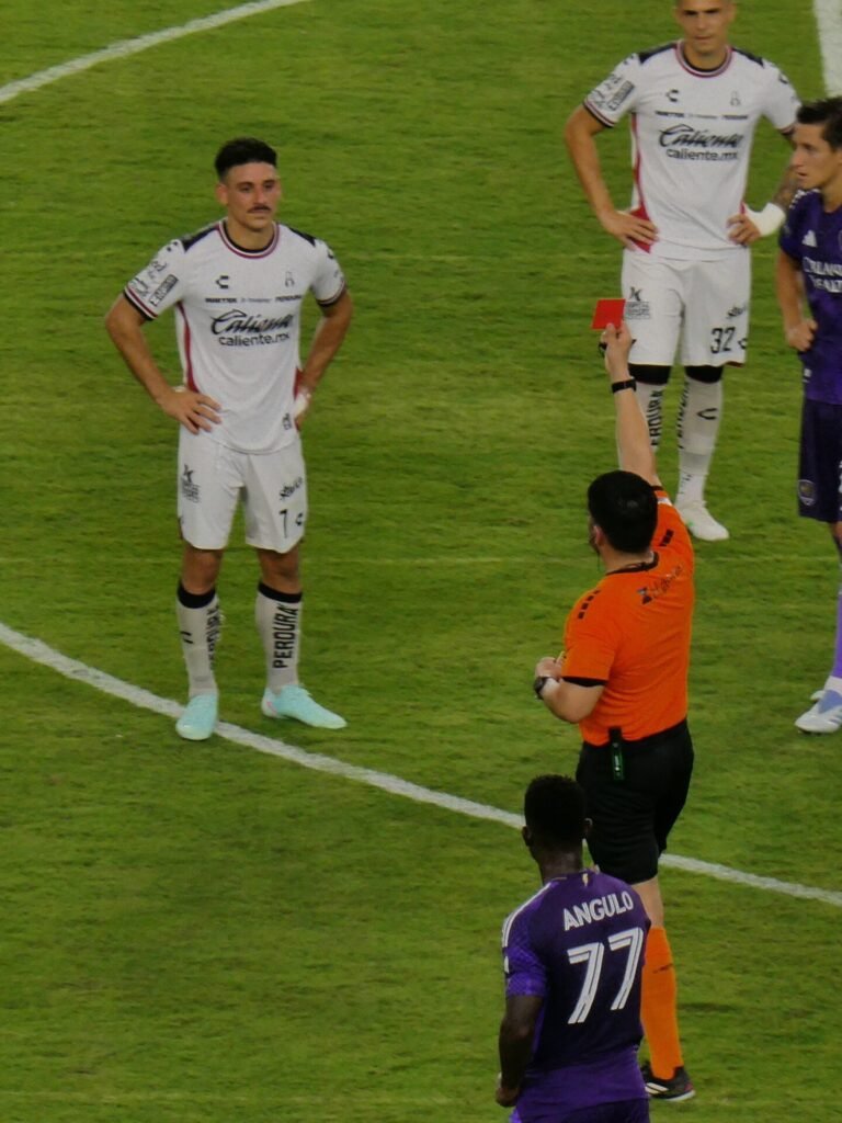 A referee shows a red card during a football match