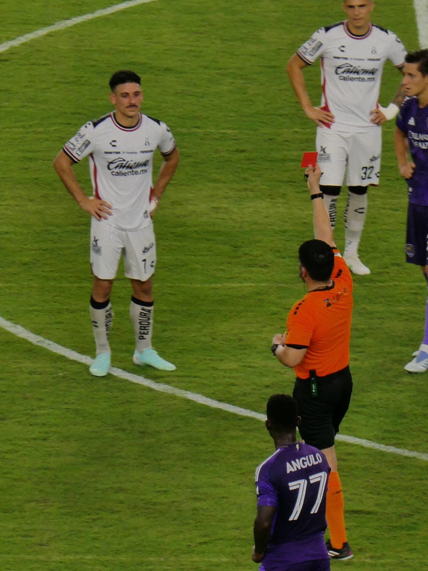 A referee shows a red card during a football match
